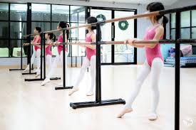 Young students practicing at the ballet barre in a Chiang Mai dance studio